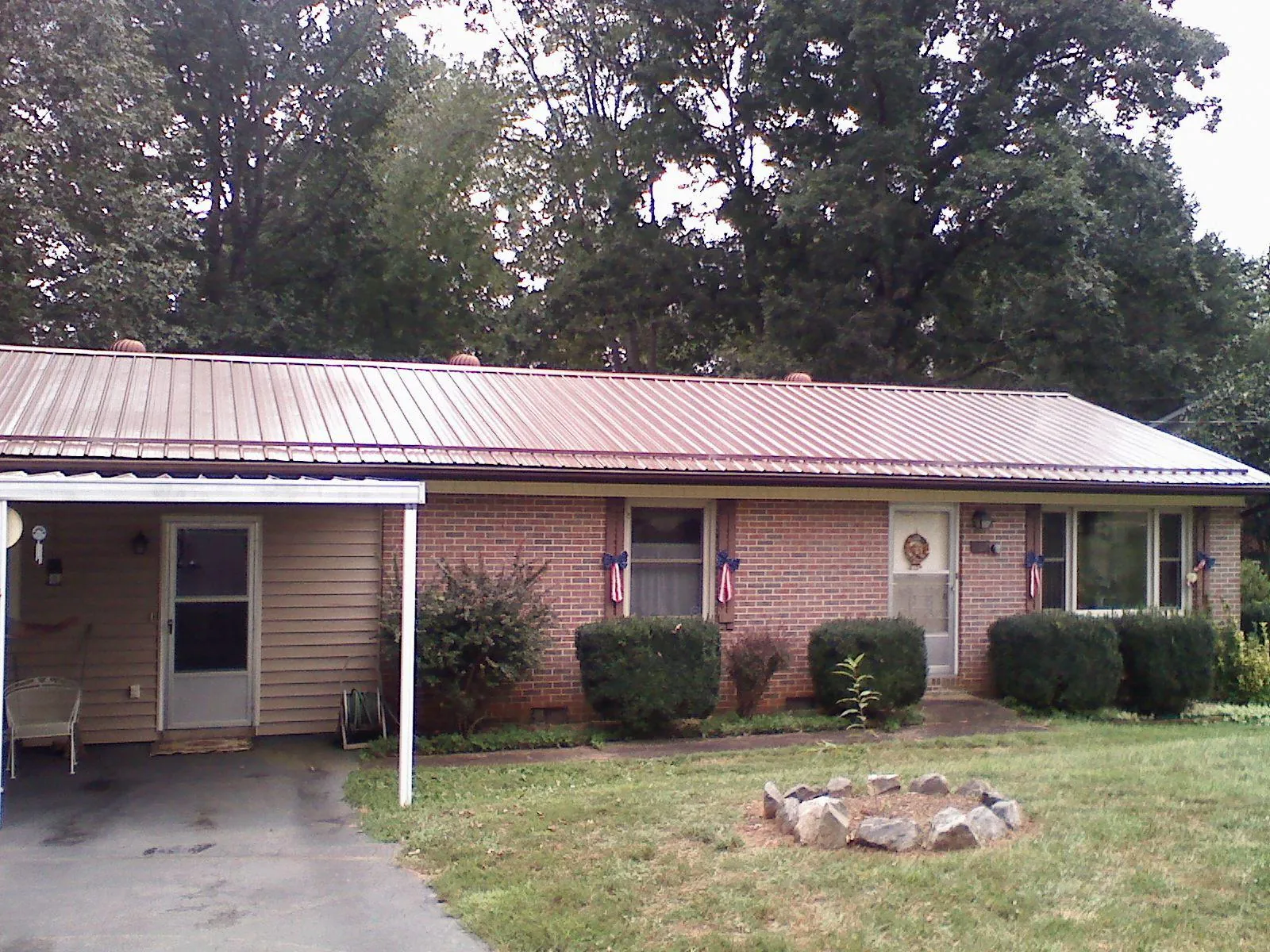 Bronze metal roof and carport on a brick ranch home — Roof Repair work by our crew in Clarkfield
