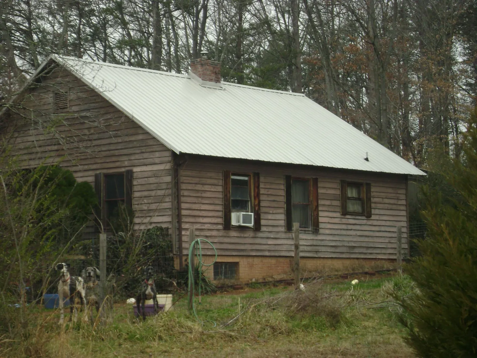 White metal roof on an old wood sided farmhouse, from a Metal Roof Installation job in Clarkfield